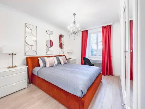 a bedroom with a large bed with red curtains at Chic 2 bedroom apartment near Chillion castle in Veytaux