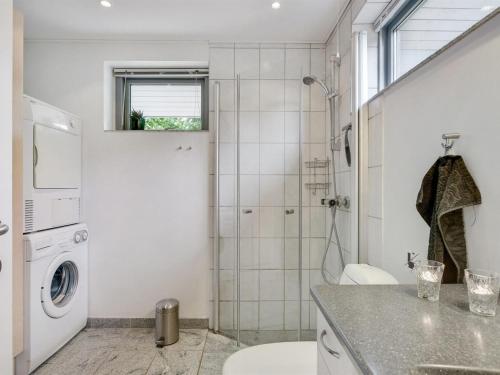 a white bathroom with a toilet and a shower at Holiday Home Freding - 250m to the inlet by Interhome in Børkop