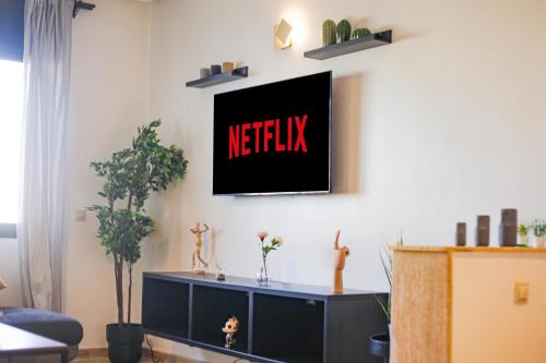 a living room with anetflix sign on the wall at YourPlace Rabat Agdal 1 - Cozy Residence in Rabat