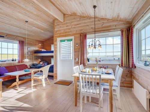 a dining room and living room with a table and chairs at Holiday Home Lenita - 30m to the inlet in The Liim Fiord by Interhome in Thisted