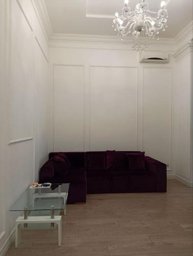 a living room with a couch and a chandelier at Hotel Menshikov in Odesa