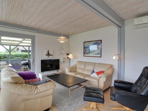 a living room with two couches and a table at Holiday Home Giselle - 150m from the sea in SE Jutland by Interhome in Sønderby