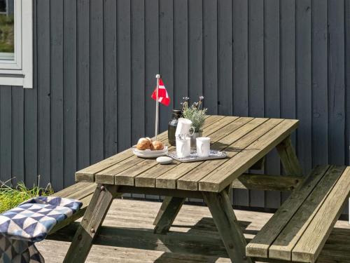 a picnic table with food and a flag on it at Holiday Home Siri - 400m from the sea in NW Jutland by Interhome in Thisted