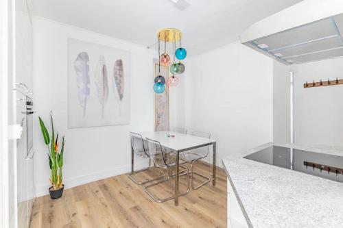 a white room with a table and a counter at Exquisite one-bedroom apartment on Av du Casino in Montreux