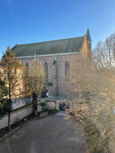 a large brick building with a tree in front of it at Hôtel Château des Jacobins in Agen