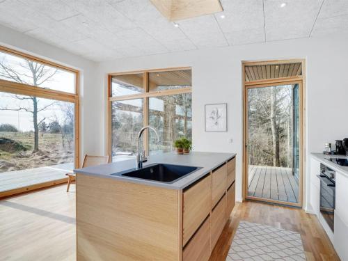 a kitchen with a sink and a large window at Holiday Home Haubert - 500m to the inlet by Interhome in Lihme