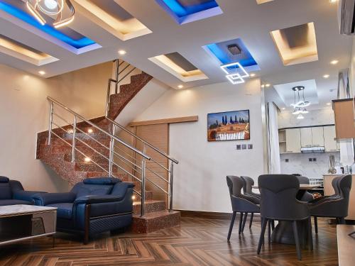 a lobby with a staircase with blue lights at Unique Apartment in Kigali