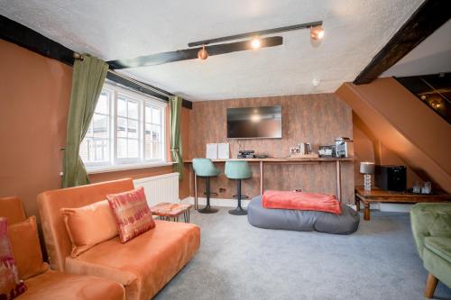 a living room with a couch and a table at Tottington Manor Hotel in Henfield