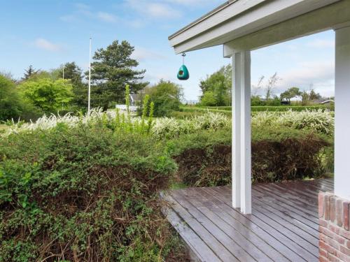 a porch of a house with a wooden deck at Holiday Home Ioar - 200m to the inlet by Interhome in Spottrup