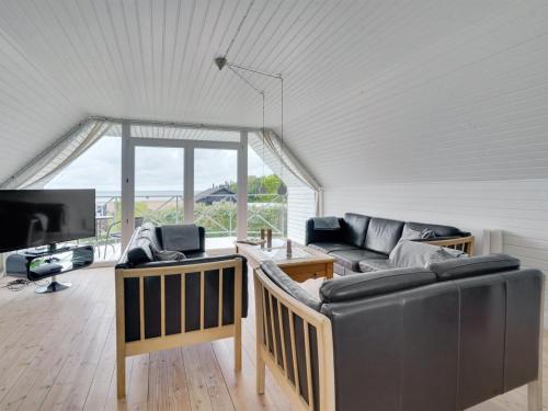 a living room with two couches and a tv at Holiday Home Dunja - 200m to the inlet by Interhome in Vinderup