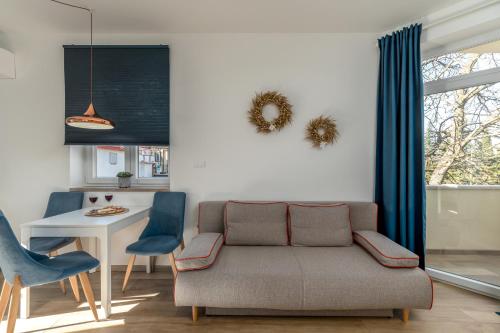 a living room with a couch and a table at Apartments Pausa in Žminj