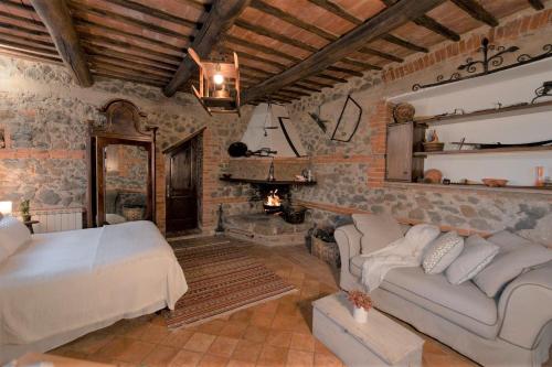 a bedroom with a bed and a fireplace at Agriturismo Borgo di Campagna Il Tesoro in Torre Alfina