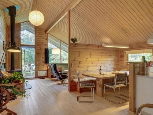 Habitación con pared de madera, mesa y sillas. en Holiday Home Andy - 500m to the inlet in The Liim Fiord by Interhome, en Spottrup