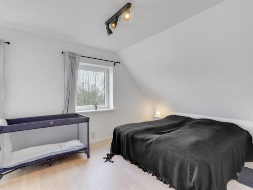 a white bedroom with a bed and a window at Holiday Home Auguste - 1-5km to the inlet by Interhome in Fur