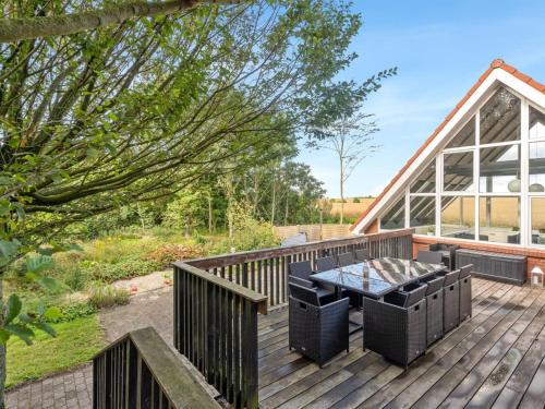 a wooden deck with a table and chairs on it at Holiday Home Auguste - 1-5km to the inlet by Interhome in Fur