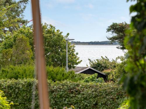 een uitzicht op een meer vanuit een huis bij Holiday Home Regni - 300m to the inlet in The Liim Fiord by Interhome in Nykøbing Mors