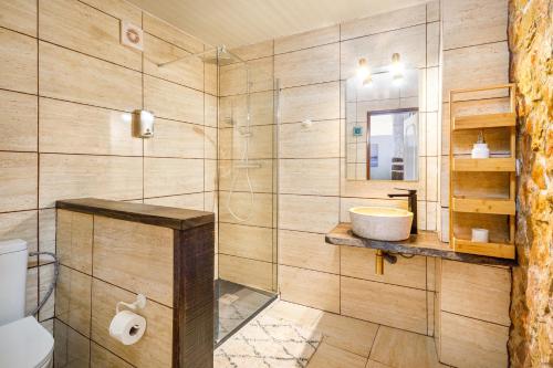 a bathroom with a sink and a glass shower at Galeria Guesthouse in Tavira