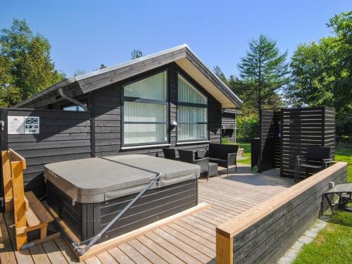 une grande terrasse avec un grill et une maison dans l'établissement Holiday Home Etly - 600m to the inlet in The Liim Fiord by Interhome, à Roslev