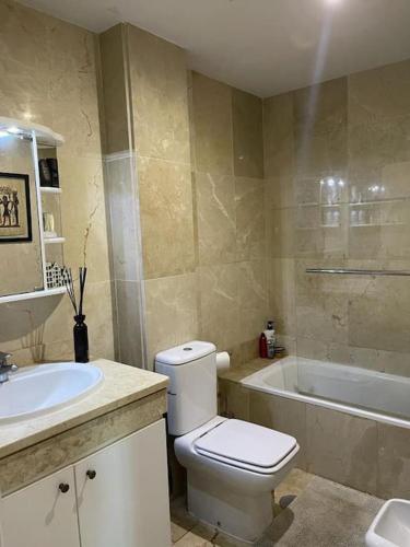 a bathroom with a toilet and a sink and a tub at Mi descanso La Cala de Mijas in La Cala de Mijas