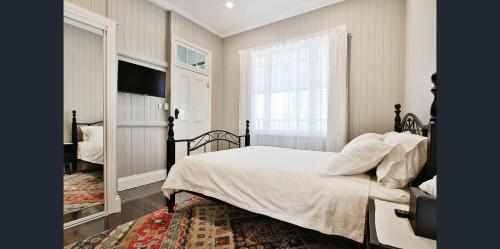 a bedroom with a white bed and a window at MJ's 2 bedroom luxury style apartment in Ipswich