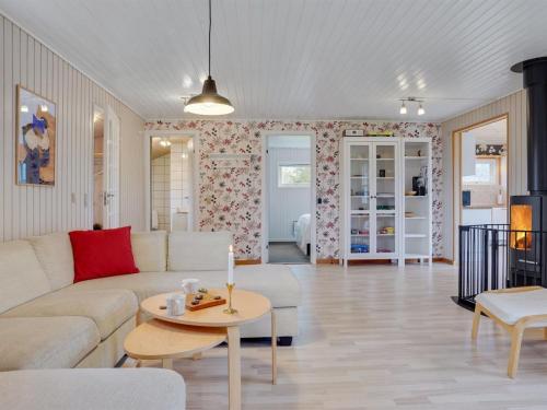 een woonkamer met een bank en een tafel bij Holiday Home Nelda - 300m to the inlet in NE Jutland by Interhome in Storvorde