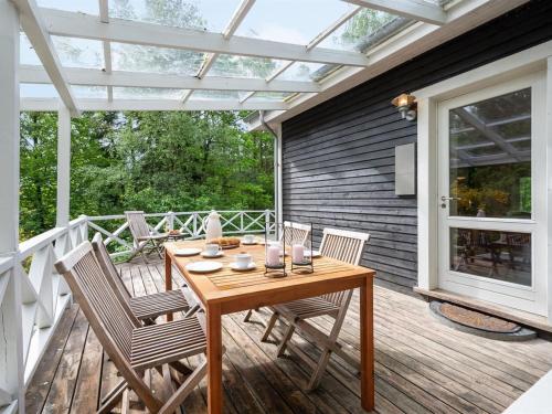 a patio with a wooden table and chairs on a deck at Holiday Home Belenda in SE Jutland by Interhome in Silkeborg