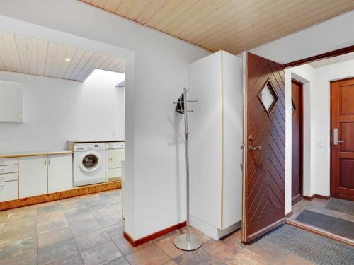an open door in a kitchen with a washing machine at Holiday Home Toska by Interhome in Silkeborg