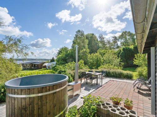 a patio with a plunge pool and a table and chairs at Holiday Home Self - 400m to the inlet in The Liim Fiord by Interhome in Løgstrup