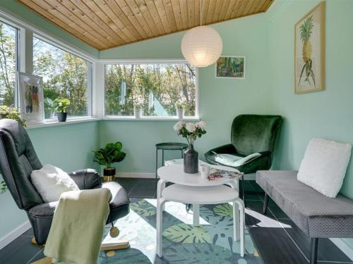 a living room with two chairs and a table at Holiday Home Akira - 500m to the inlet by Interhome in Storvorde