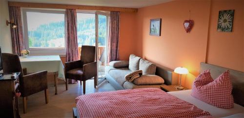 a bedroom with a bed and a living room at Gästehaus Eckstein in Oy-Mittelberg