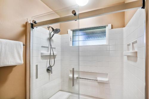 a bathroom with a shower with a glass door at Keauhou Resort 113 in Kailua-Kona