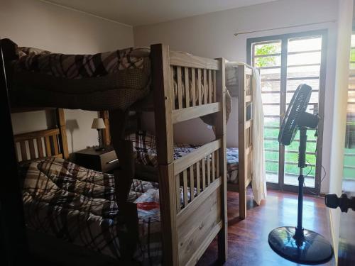 two bunk beds in a room with a window at Tres Jolie in Guaymallen