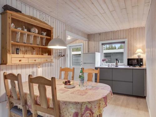 eine Küche und ein Esszimmer mit einem Tisch und Stühlen in der Unterkunft Holiday Home Sissa - 1-5km from the sea in NE Jutland by Interhome in Hals