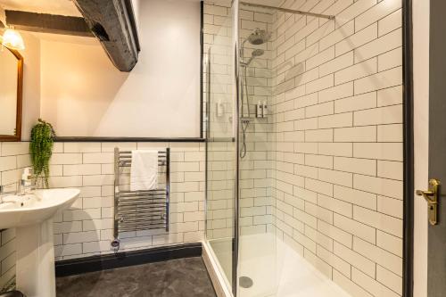 a bathroom with a shower and a sink at Royal Oak Pub in Cartmel