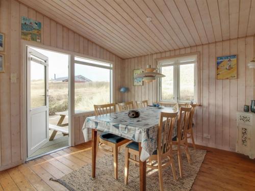 a dining room with a table and chairs at Holiday Home Adi - 75m from the sea in NW Jutland by Interhome in Løkken