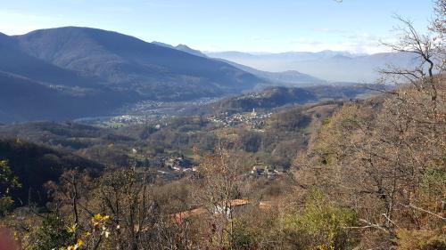 a view of a town in a valley with mountains at Casa al Sasso in Bedigliora