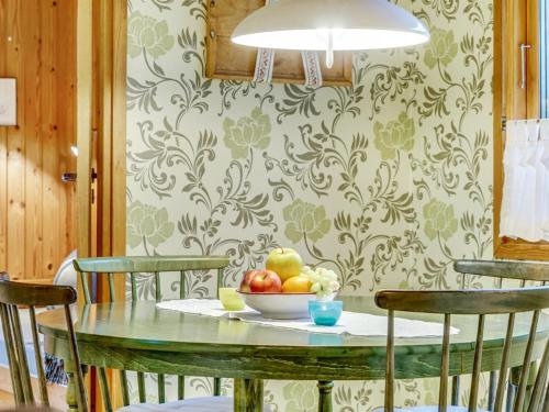 a dining room table with a bowl of fruit on it at Holiday Home Carina - 5km from the sea by Interhome in Brovst