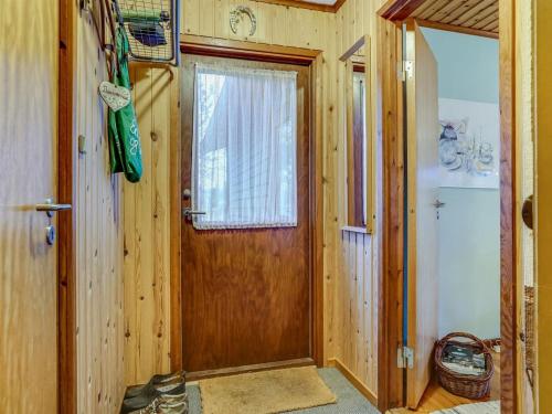 a wooden door with a window in a room at Holiday Home Carina - 5km from the sea by Interhome in Brovst
