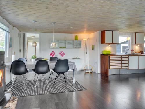 a kitchen with a table and chairs in a room at Holiday Home Edel - 650m from the sea by Interhome in Hadsund