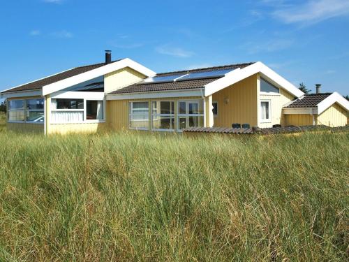a house with solar panels on top of a field at Holiday Home Thorir - 300m from the sea in NW Jutland by Interhome in Hirtshals