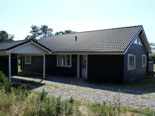 a black house with a white at Holiday Home Jurgis - 300m from the sea by Interhome in Læsø