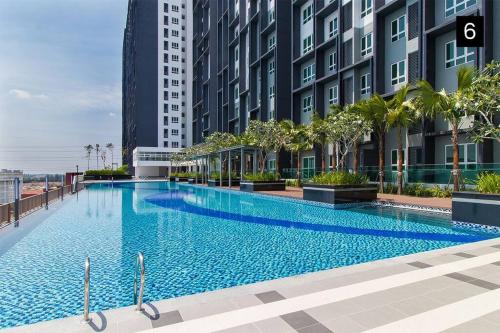 a large swimming pool in the middle of a building at Impiria Residensi #Link Aeon Mall Klang 4BR3Bath in Klang