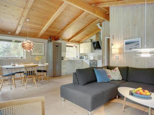 a living room with a couch and a table at Holiday Home Thorger - 3km from the sea in NE Jutland by Interhome in Læsø