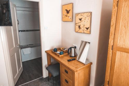 a bathroom with a wooden desk with a mirror and a shower at Croppers Arms in Huddersfield