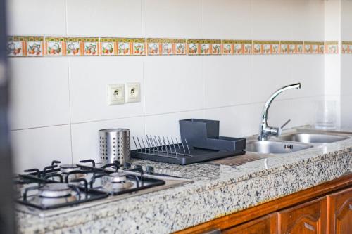 a kitchen counter with a stove and a sink at YourPlace Rabat Agdal 1 - Cozy Residence in Rabat
