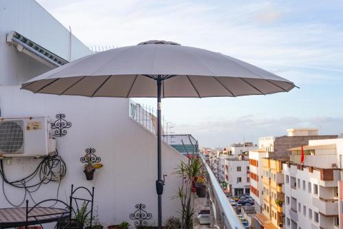 a white umbrella sitting on top of a balcony at YourPlace Rabat Agdal 1 - Cozy Residence in Rabat