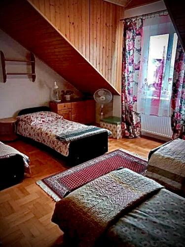 a living room with two beds and a staircase at Pokój prywatny 4 osobowy ze wspólna kuchnia i łazienka in Łowicz