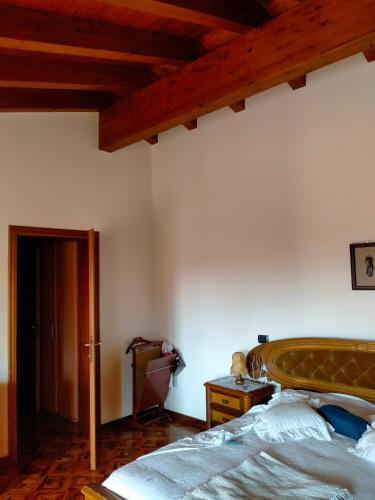 a bedroom with a bed and a wooden ceiling at Margherita in Boccon