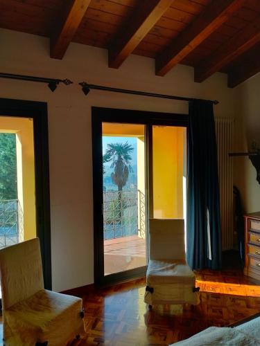 a room with two chairs and a sliding glass door at Margherita in Boccon