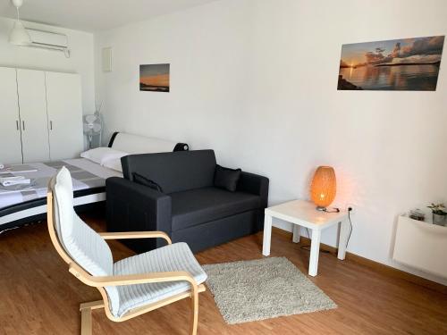 een woonkamer met een bank en een bed bij Apartments Cvijet Mora Sreser in Sreser